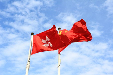 flags of China and Hong kong with blue skyの写真素材
