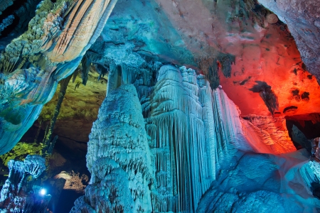 colorful limestone cave with perfect reflections in waterの写真素材