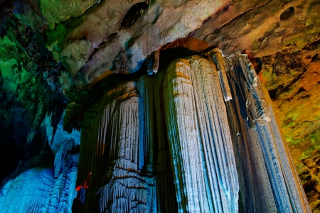 colorful limestone cave with perfect reflections in waterの写真素材