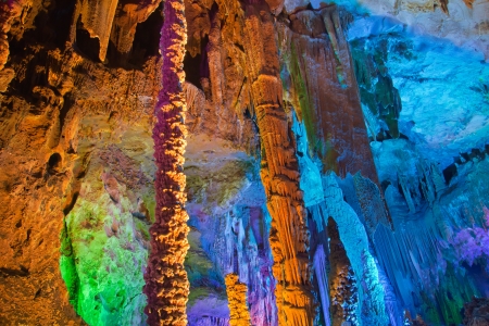 colorful limestone cave with perfect reflections in waterの写真素材