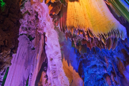 colorful limestone cave with perfect reflections in waterの写真素材