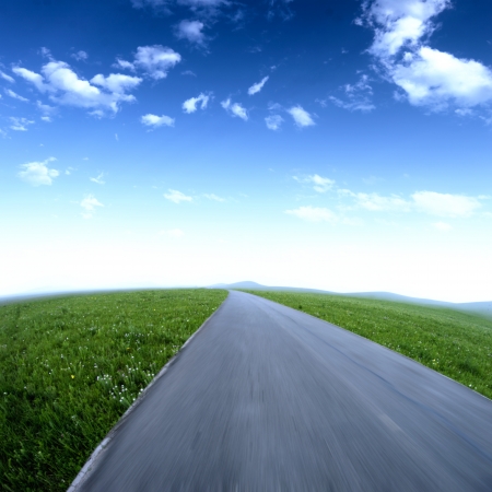 Empty asphalt road with cloudy sky and sunlightの写真素材