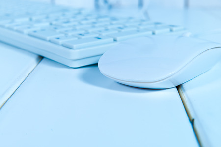 White computer mouse on the keyboardの写真素材