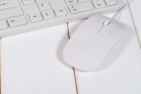 White computer mouse on the keyboardの写真素材