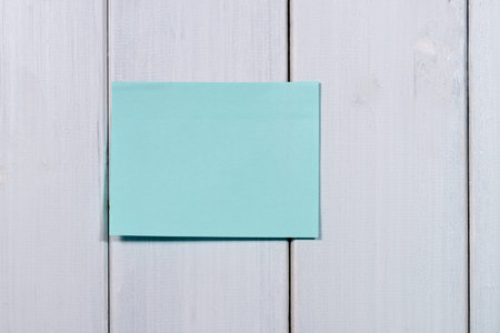 Note paper stick on wood background