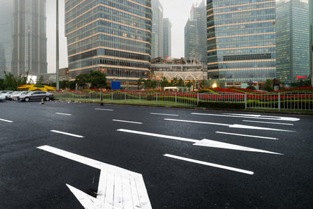 asphalt road leading into the city at nightのeditorial素材