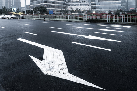asphalt road leading into the city at nightのeditorial素材