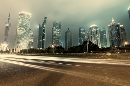 the light trails on the modern building background in shanghai chinaのeditorial素材