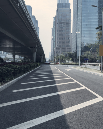 empty asphalt road of a modern city with skyscrapersのeditorial素材