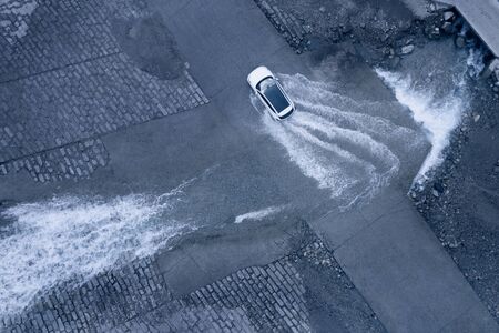 Car tire splashing in waterの写真素材