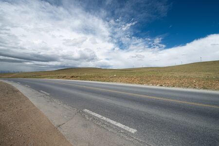 highway and snow mountain in tibet plateauの写真素材