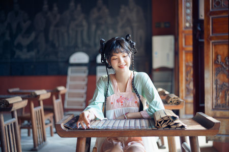 The girl in traditional Chinese dress is in the gardenの写真素材