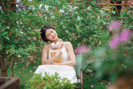 The girl is reading in the yardの写真素材