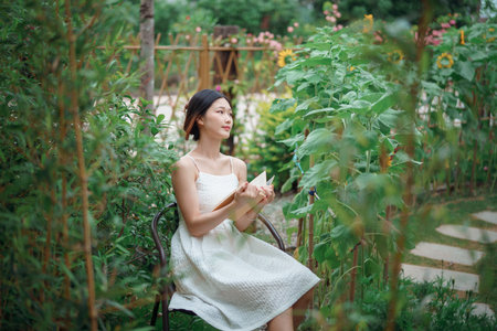 The girl is reading in the yardの写真素材