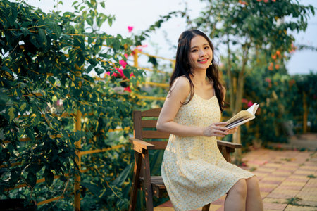 The girl is reading in the yardの写真素材