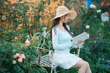 Young girls read books in the gardenの写真素材