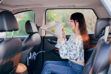 Fashionable Asian girls make up in the carの写真素材