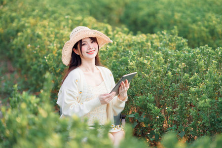 Girls use tablet computers in the park