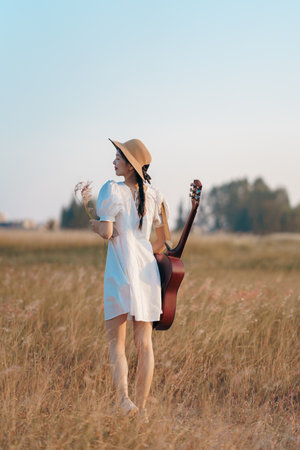 happy girl playing guitar at parkの写真素材