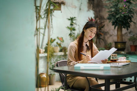 Asian girls work in the courtyardの写真素材