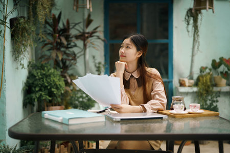 Asian girls work in the courtyardの写真素材