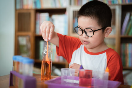 Little boy doing chemical experiment in laboratoryの写真素材