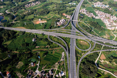 Aerial view of highway interchange Road junction Aerial photo of a highway going through the forest