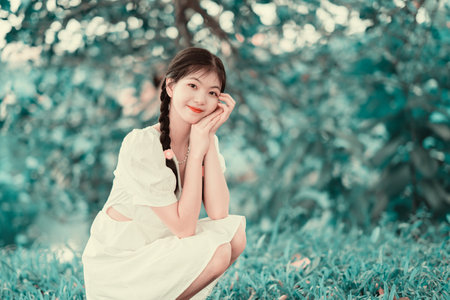 The young girl is in the gardenの写真素材