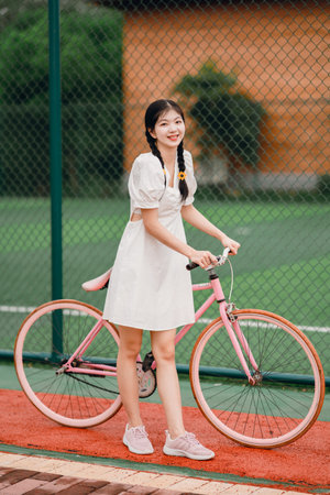 Female college students push bicyclesの写真素材