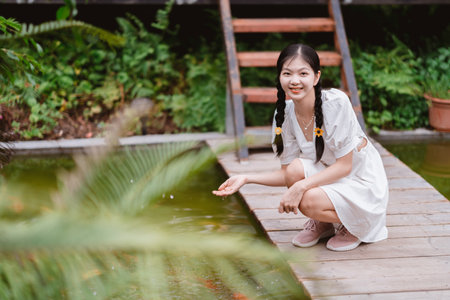 The young girl is in the gardenの写真素材