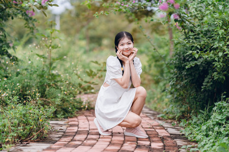 The young girl is in the gardenの写真素材