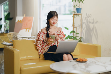 Beautiful Asian girl working at homeの写真素材