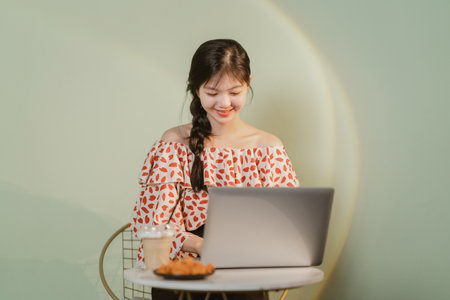 Beautiful Asian girl working at homeの写真素材