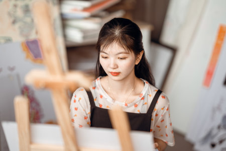 The girl is drawing in the studioの写真素材
