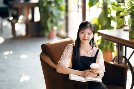 The girl reads in the coffee shopの写真素材