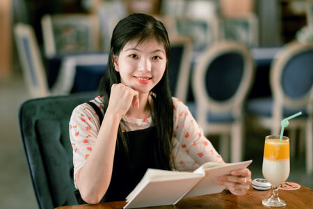 The girl reads in the coffee shopの写真素材