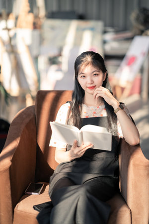 The girl reads in the coffee shopの写真素材