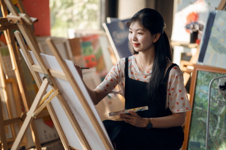 The girl is drawing in the studioの写真素材
