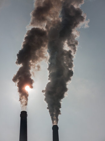 The smoke from the chimneys of a power plant