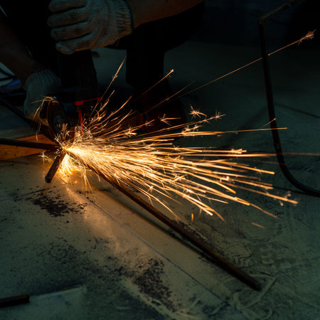 metal cutting saw close up throwing sparks all over in a workshop