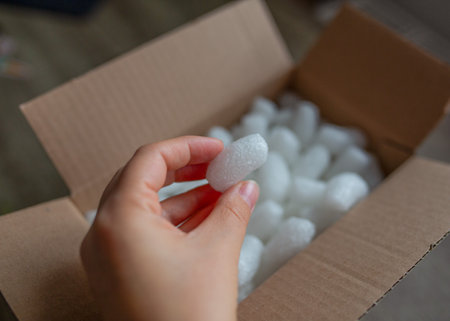 Eco packaging of parcels and white biodegradable filler. Box is filled with a filler safety for environment.の写真素材
