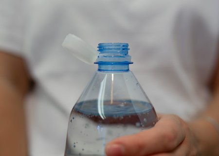 Close up of hand holding a bottle of clean water, clean water concept