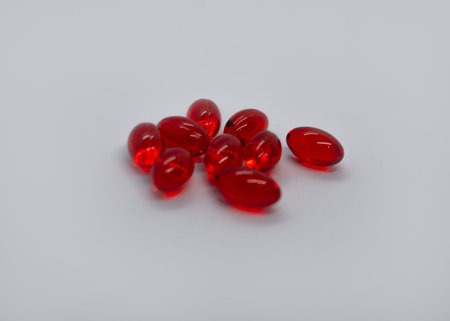 Red pills isolated on white background.