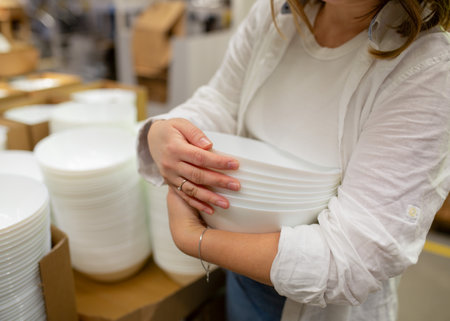 A young woman chooses dishes in a store, Close-up of handsの写真素材