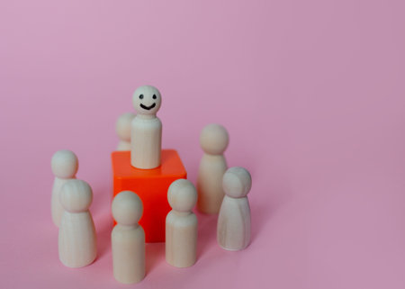 Introvert, Individuality Person. Unique man happy and enjoy isolation. Separation or Solitude person. Wooden figure with happy face split line from the crowd.の写真素材