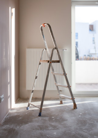Empty room of new building during reconstruction. Stepladder in construction site inside apartment during repair works.の写真素材