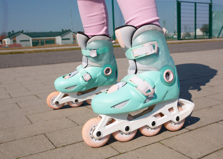 Close up of little girl roller skating in the park