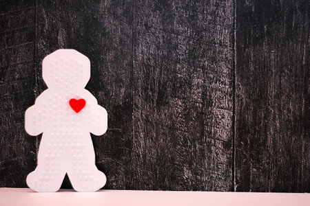 Plastic figure of a man with a red heart. concept of love. Valentine's day. Copy Space.
