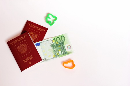 The passport of the Russian Federation. Biometric russian passports and euro for the trip. Plastic figures of the ship and the plane.の写真素材