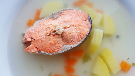 Seafood soup. Soup with salmon in a white plate. The concept of healthy eating.の写真素材